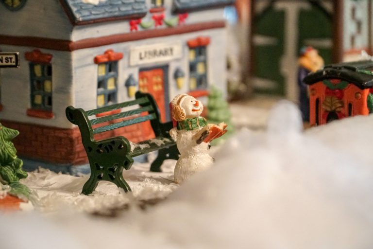 A model snowman and bench